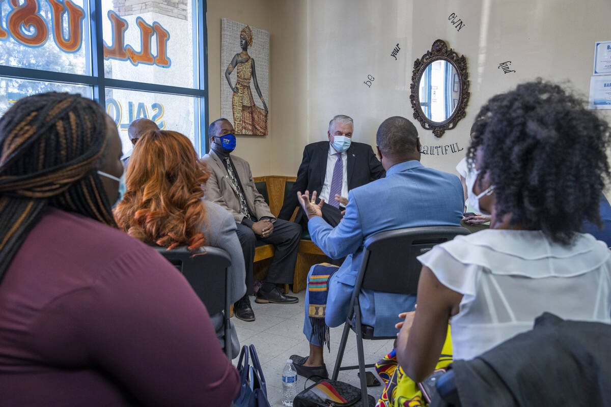 Gov. Steve Sisolak , center, listens to an introduction as he meets with Black business owners ...
