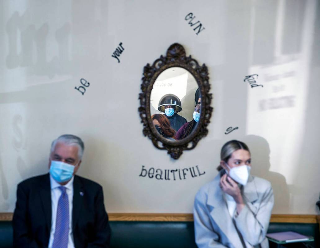 A customer looks on as Gov. Steve Sisolak, left, meets with Black business owners at Illusion S ...