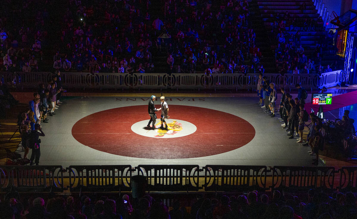 Competitors meet in the center of the mat after being introduced during the 4A state wrestling ...