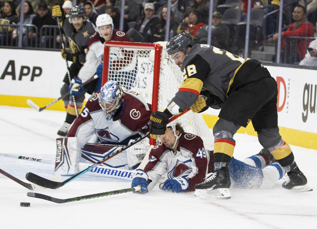 Golden Knights left wing William Carrier (28) shoots on Colorado Avalanche goaltender Darcy Kue ...