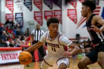 Liberty’s Dedan Thomas (11) drives around Durango’s Colton Knoll (13) during a high school ...