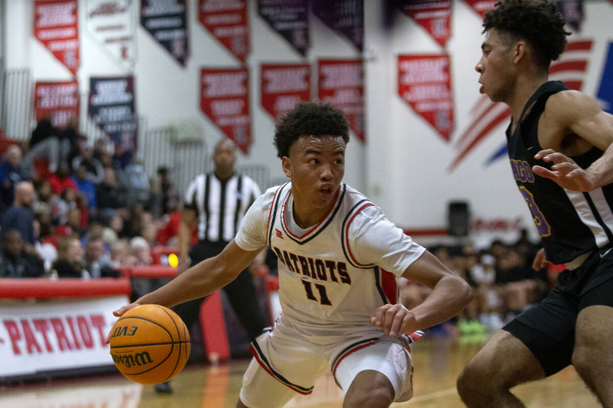 Liberty’s Dedan Thomas (11) drives around Durango’s Colton Knoll (13) during a high school ...