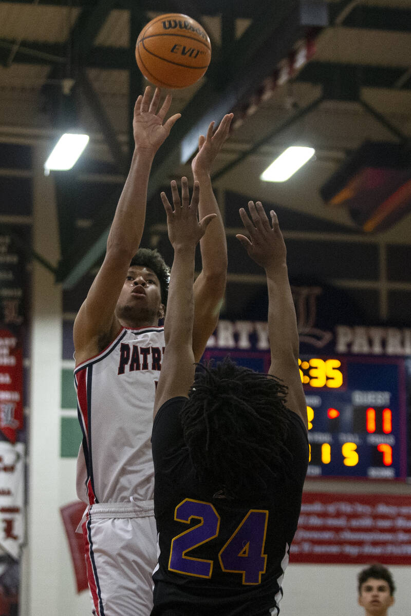 Liberty’s Joshua Jefferson (5) shoots against Durango’s Taj Degourville (24) during a high ...