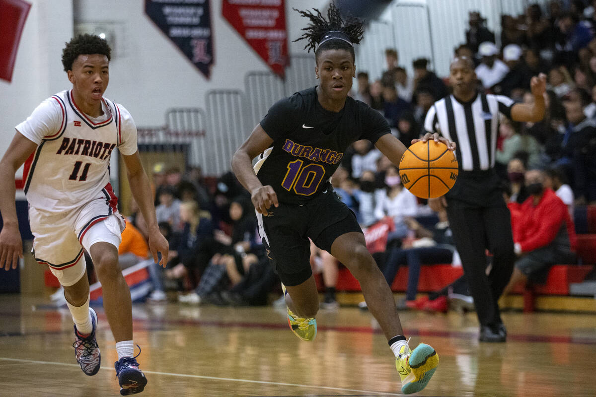 Durango’s Tylen Riley (10) dribbles around Liberty’s Dedan Thomas (11) during a h ...