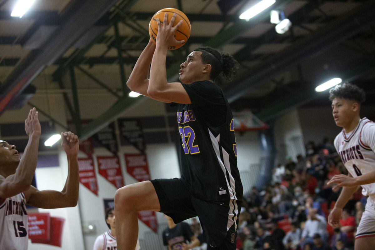 Durango’s Sterling Knox (32) shoots against Liberty’s Aaron Price (15) during a h ...
