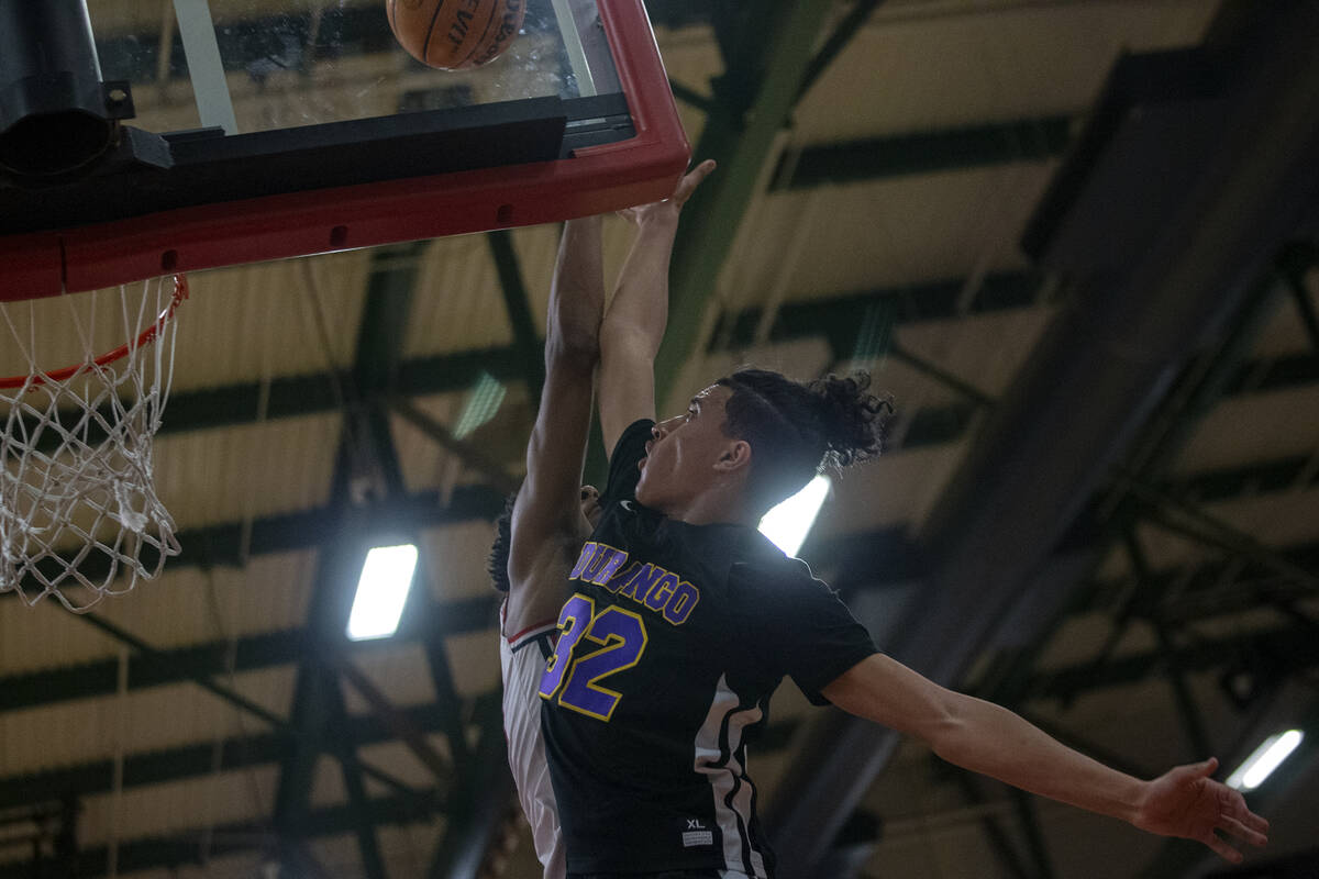 Durango’s Sterling Knox (32) shoots against Liberty’s Aaron Price (15) during a h ...