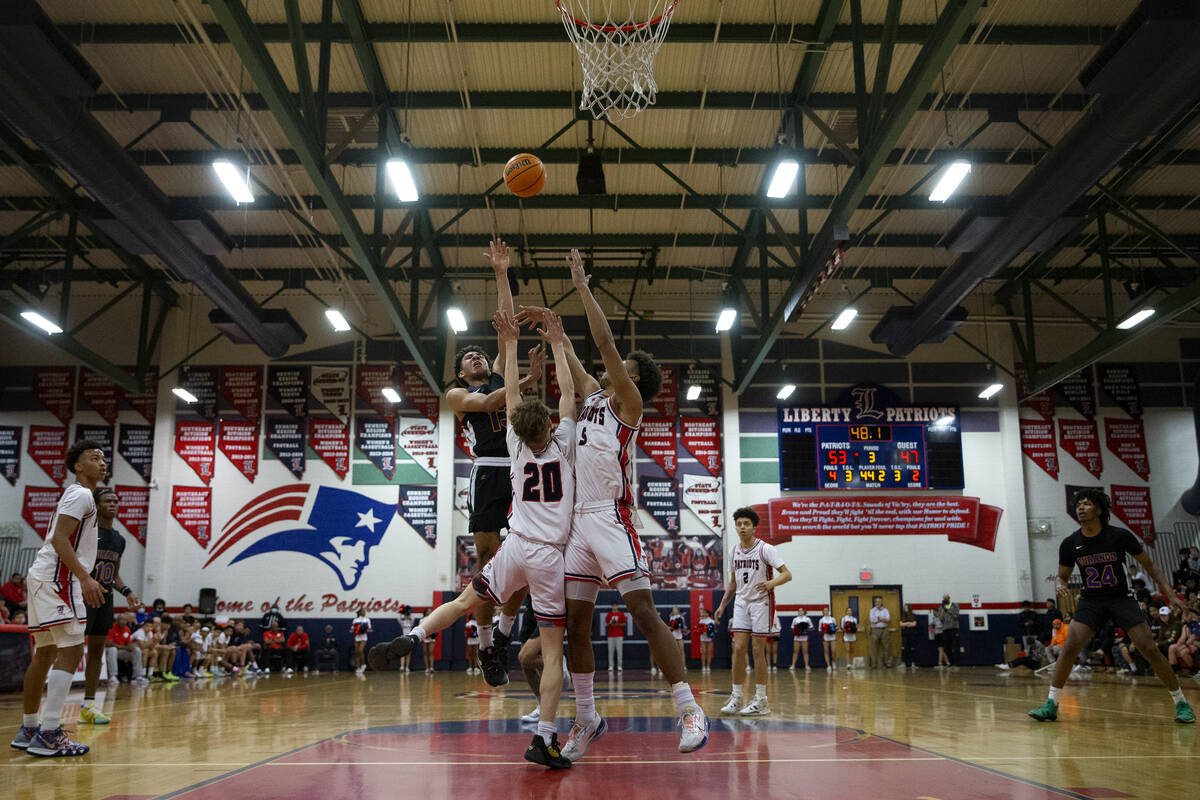 Durango’s Colton Knoll (13) shoots against Liberty’s Mason Muir (20) and Joshua J ...