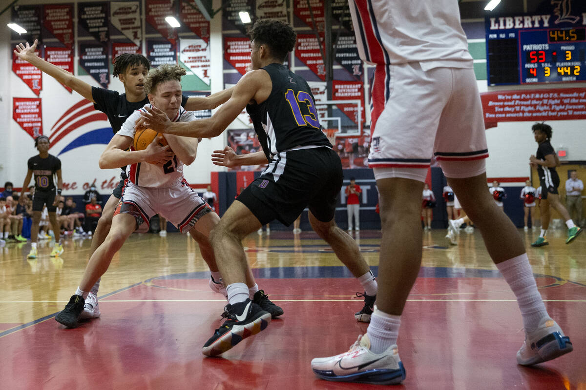 Liberty’s Ariel Clark (21) competes for the ball with Durango’s Cameron Mendoza, ...