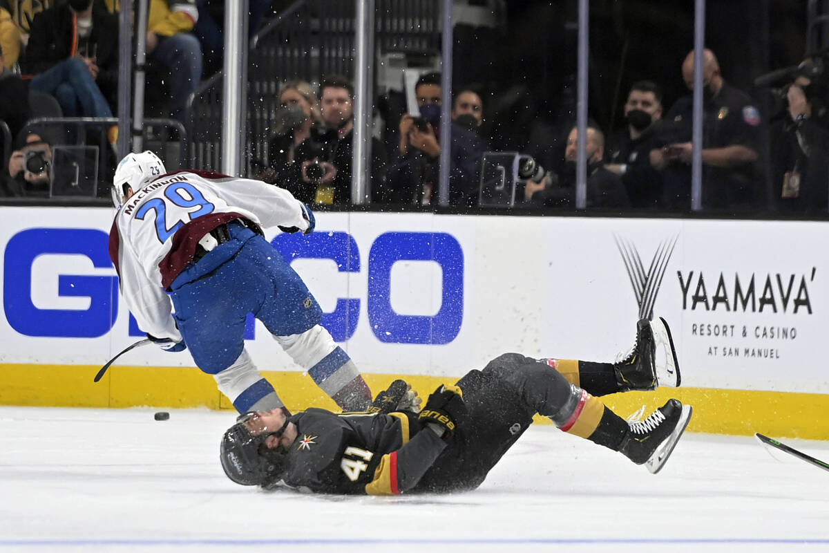 Vegas Golden Knights center Nolan Patrick (41) falls to the ice after being hit by Colorado Ava ...