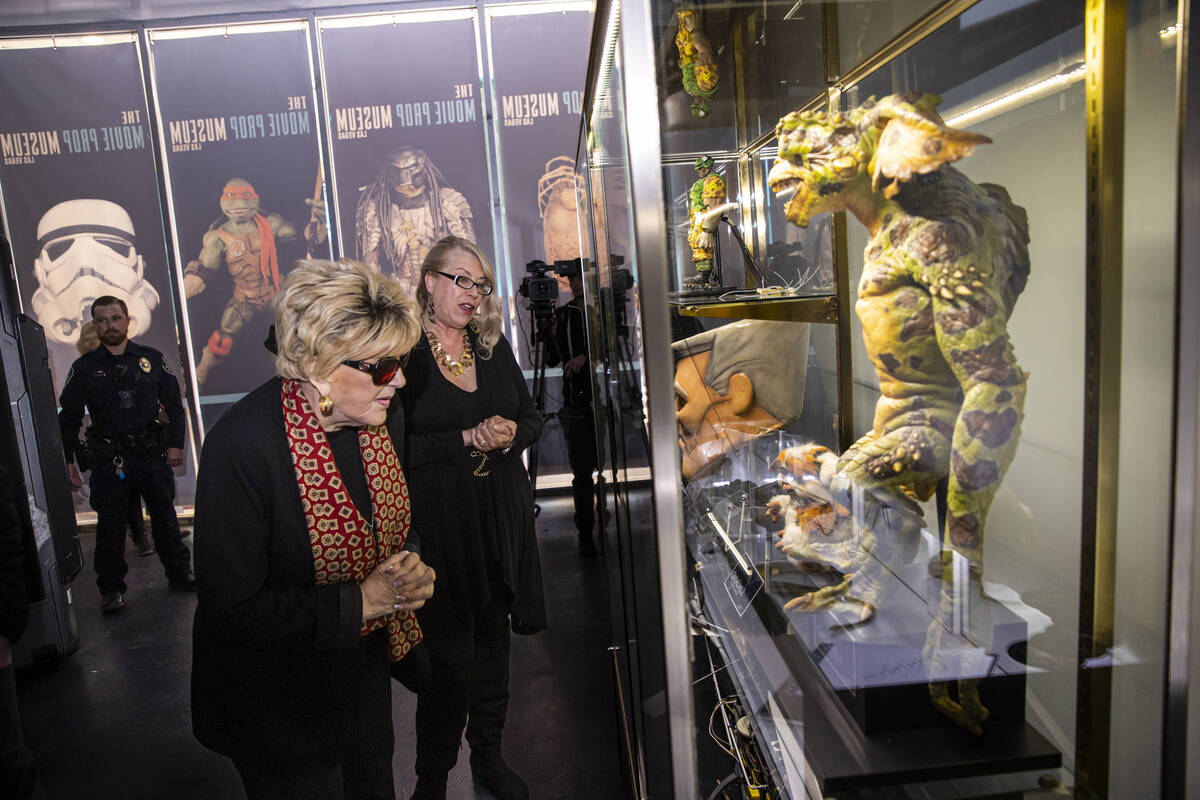 Tiana Armstrong, coowner of The Movie Prop Experience, right, gives a