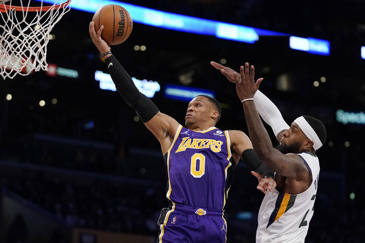 Los Angeles Lakers guard Russell Westbrook, left, shoots as Utah Jazz forward Royce O'Neale def ...