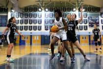 Centennial’s Asani Ceaser (32) shoots against Desert Oasis’ Paige Parlanti (24) during a hi ...