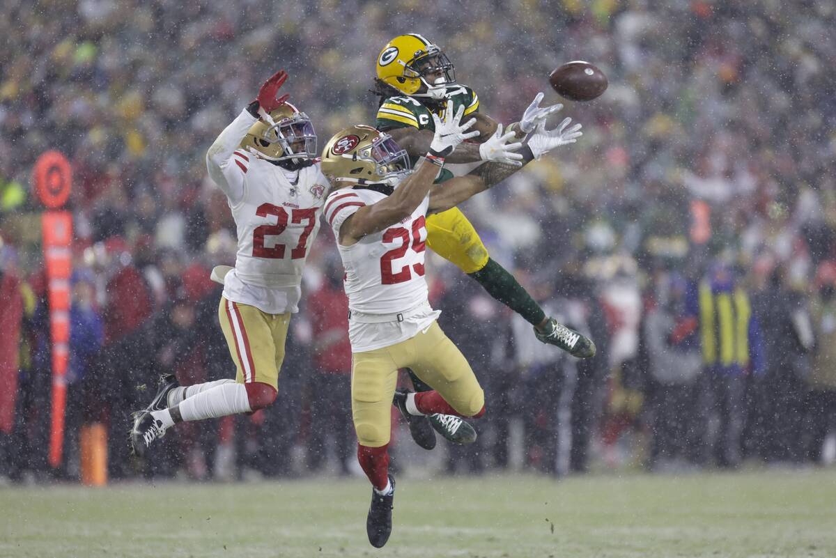 San Francisco 49ers' Talanoa Hufanga and Dontae Johnson break up a pass  intended for Green Bay …