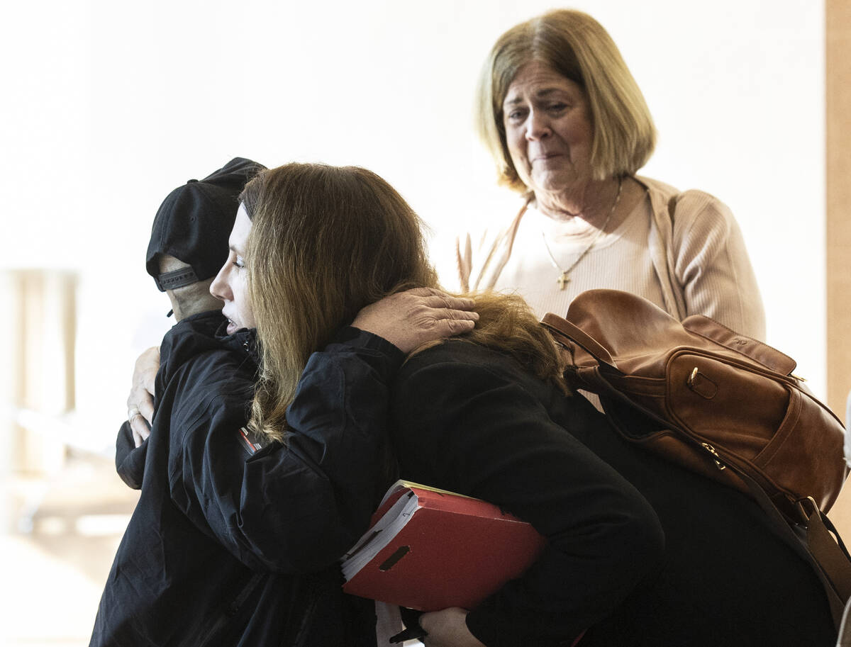 Stanley Aoyagi, the husband of Sheri Lynn Aoyagi, hugs Pamela Weckerly, a prosecutor, after Kam ...