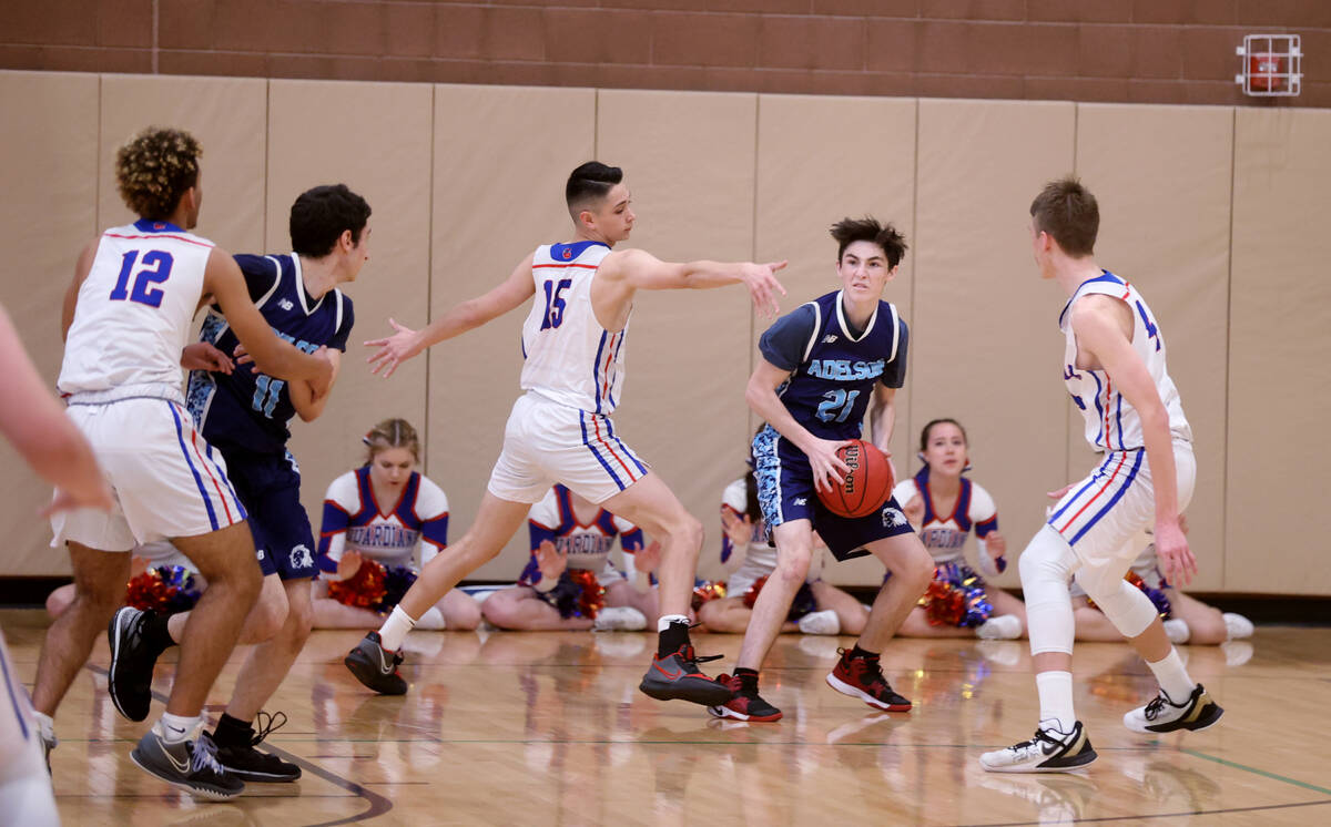 Adelson Yaakov Polonsky (21) looks to pass the ball between Green Valley Christian’s Tho ...
