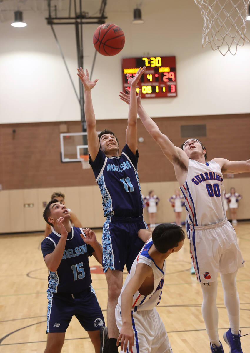 Adelson’s Michael Cohen (11) goes up for a rebound against Green Valley Christian&#x2019 ...
