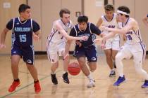 Adelson’s Judah Hafter (24) moves the ball between Green Valley Christian’s Scott ...