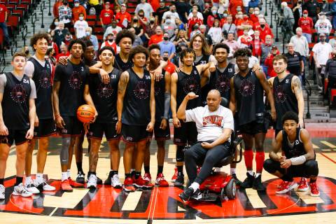UNLV basketball players pose for a picture with former player Robert Smith after an open basket ...