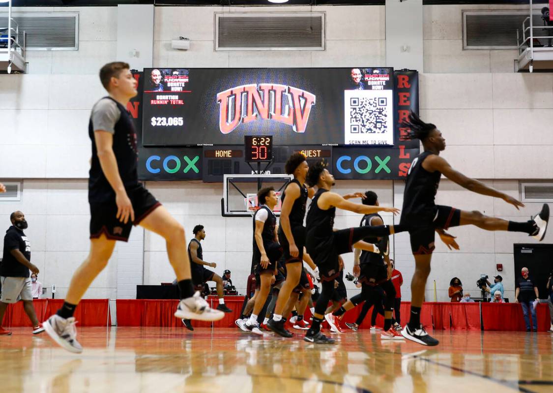 UNLV players warm up during an open basketball practice and fundraiser for former player Robert ...