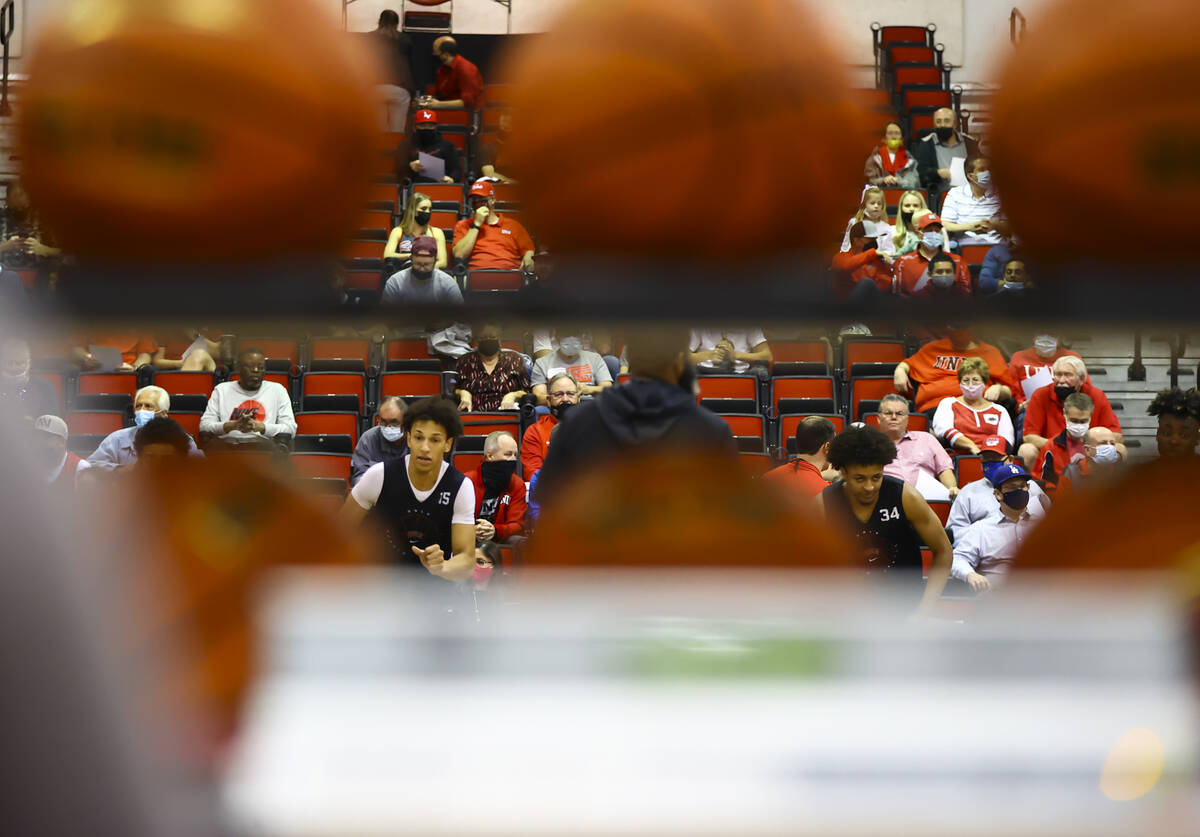 UNLVÕs Reece Brown (15) and Cameron Burist (34) warm up during an open basketball practice ...