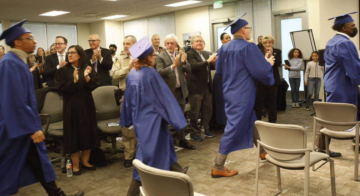 Students walk into a graduation ceremony of HOPE for Prisoners at the Metropolitan Police Depar ...