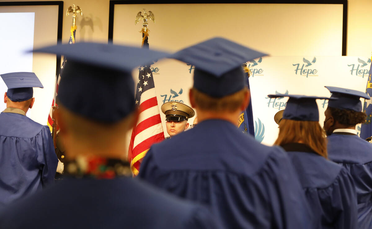 Metropolitan Police Department honor guard Jason Kephart holds a flag during a graduation cerem ...