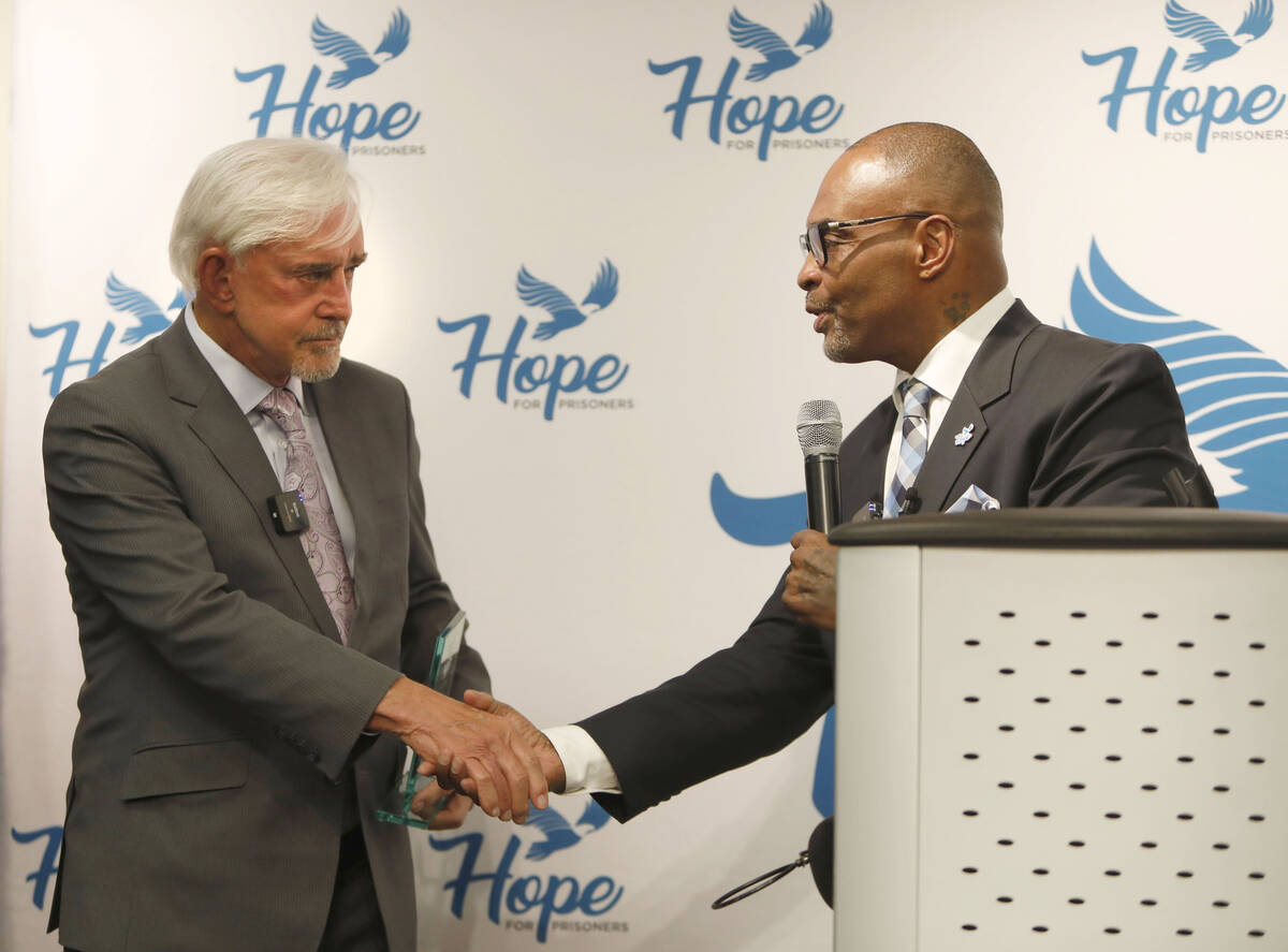 Billy Walters, left, shakes hands with Jon Ponder, founder and CEO of HOPE for Prisoners, durin ...