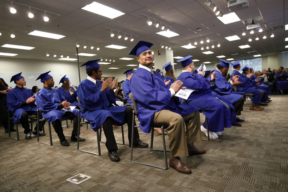 Students including Daniel Agudo, center, applaud during a graduation ceremony of HOPE for Priso ...