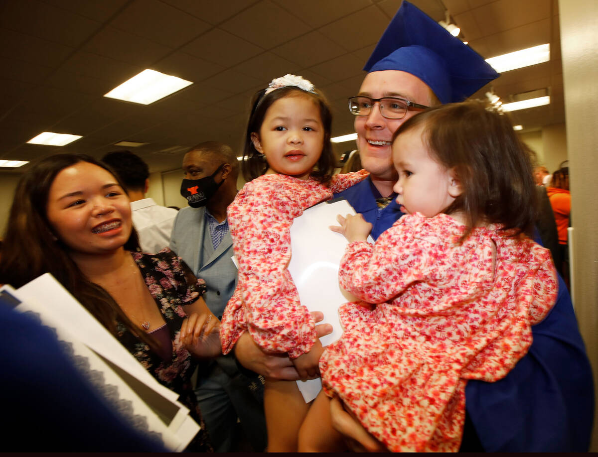 Trevor Husa holding his daughters Andy, 3, and Ana, 1, celebrates with his fiancee Angel Panes ...