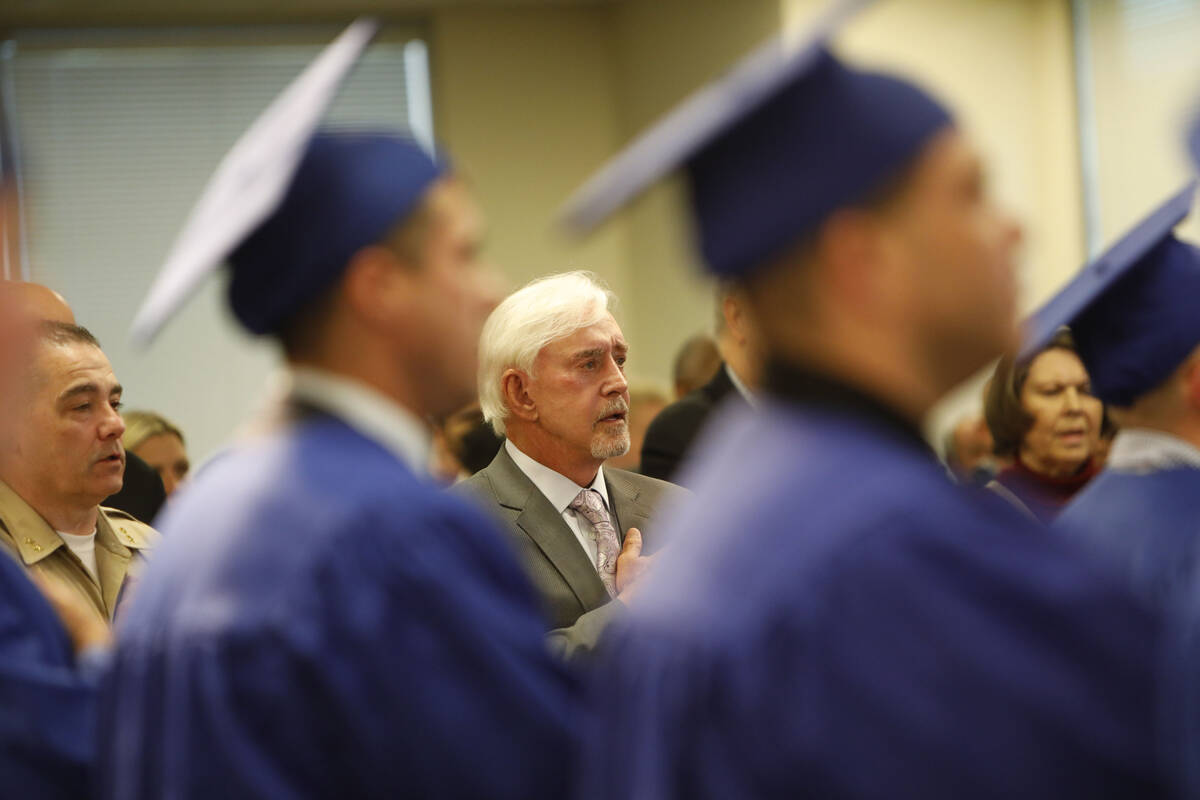 Billy Walters, center, is seen during the national anthem at a graduation ceremony of HOPE for ...