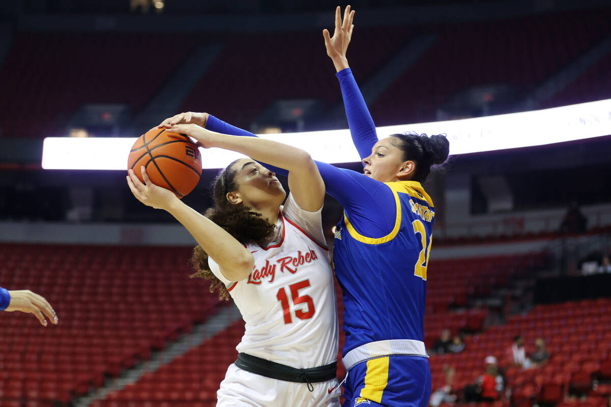 UNLV Lady Rebels Keyana Wilfred (15) goes up for a shot under pressure from San Jose Spartans M ...
