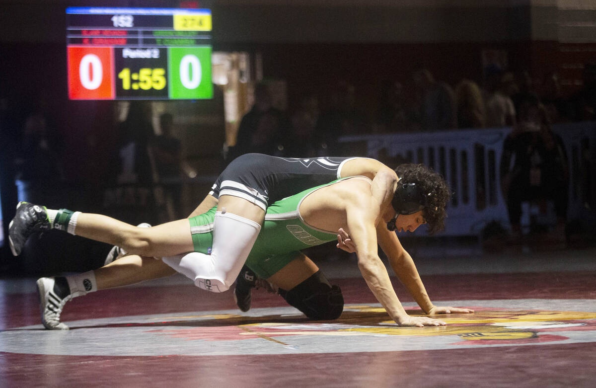 Kasius Graham from SLAM Nevada, top, wrestles Tyson Cuamba from Green Valley High School, durin ...