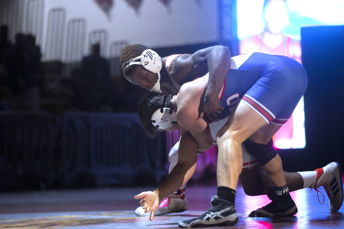 Liberty High School’s Melvin Whitehead, top, wrestles Reno High School’s Adam Cla ...