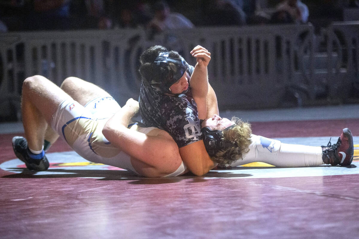 Cimarron-Memorial High School’s Jayden Johnson, right, works to pin Reed High School ...