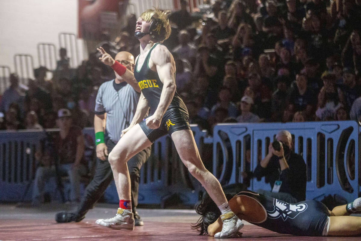 Bishop Manogue’s Carter Tate, center, celebrates his pin of SLAM Nevada’s Tyler K ...