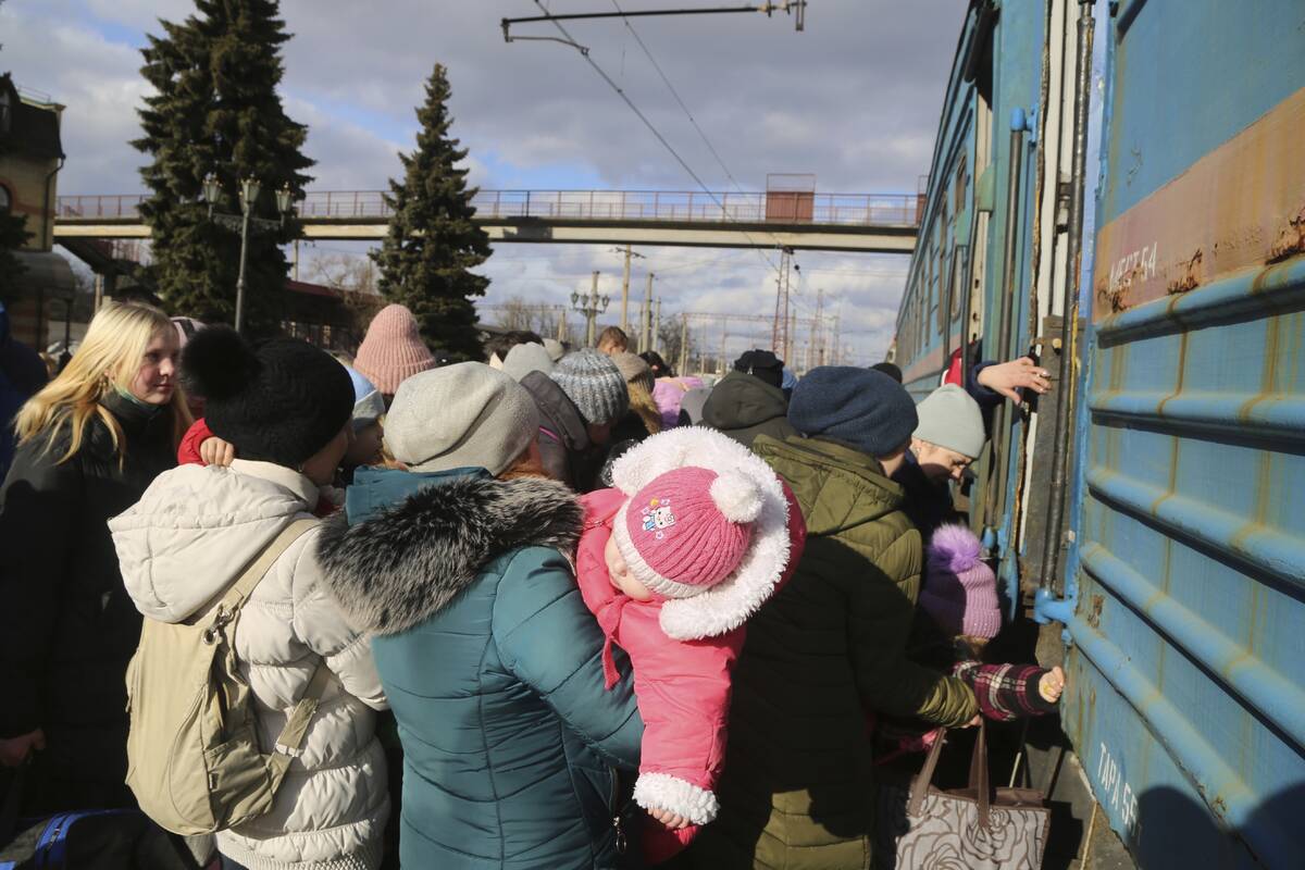 Local citizens line up to take a train at the railway station to be evacuated to Russia, in Deb ...