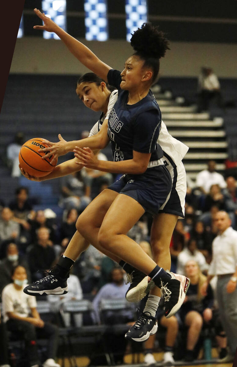 Centennial High School's Danae Powell (11) jumps to the basket as Spring Valley High School's M ...