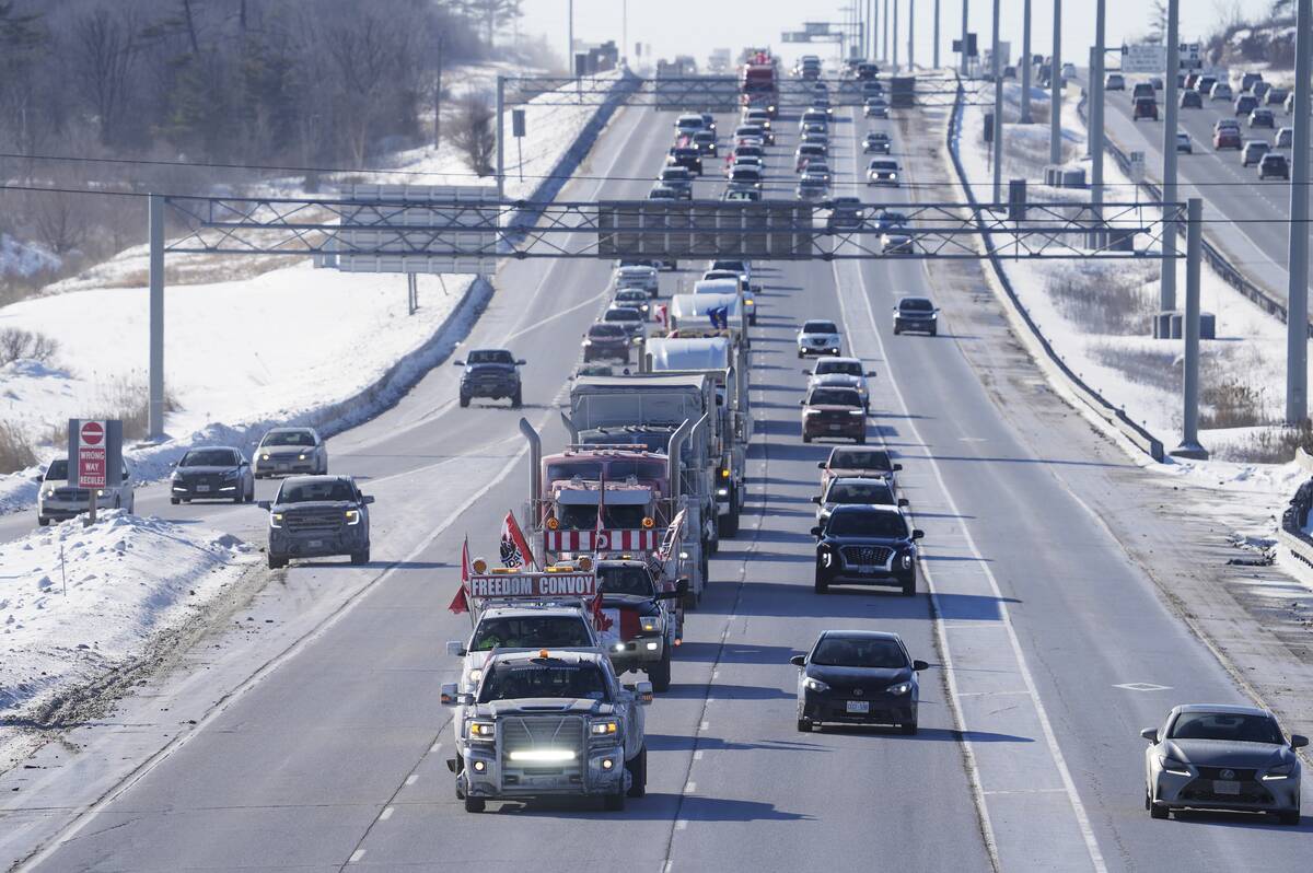 A trucker convoy driving to Parliament Hill in Ottawa to participate in a cross-country truck c ...