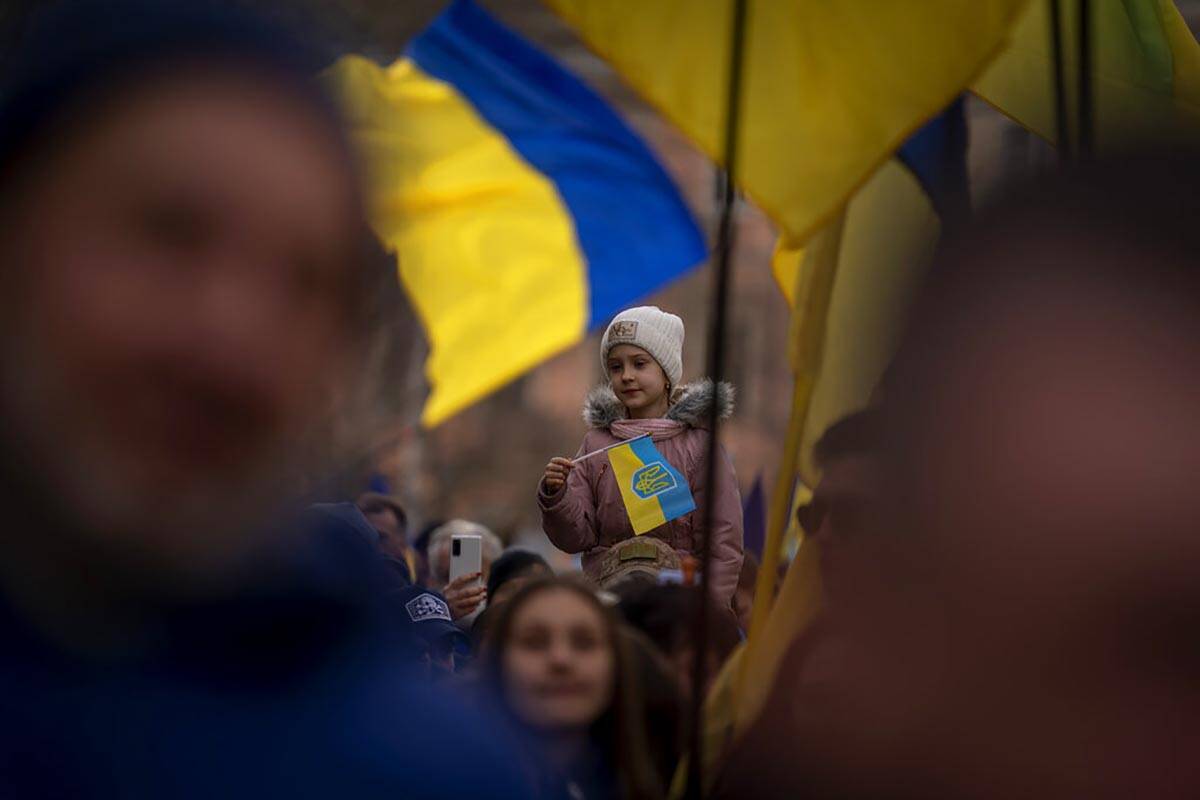 Demonstrators march along the street in Odessa, Ukraine, Sunday, Feb. 20, 2022.Thousands of peo ...