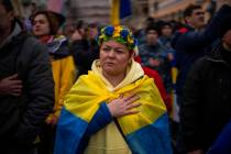 Demonstrators sing the national anthem during a protest in Odessa, Ukraine, Sunday, Feb. 20, 20 ...