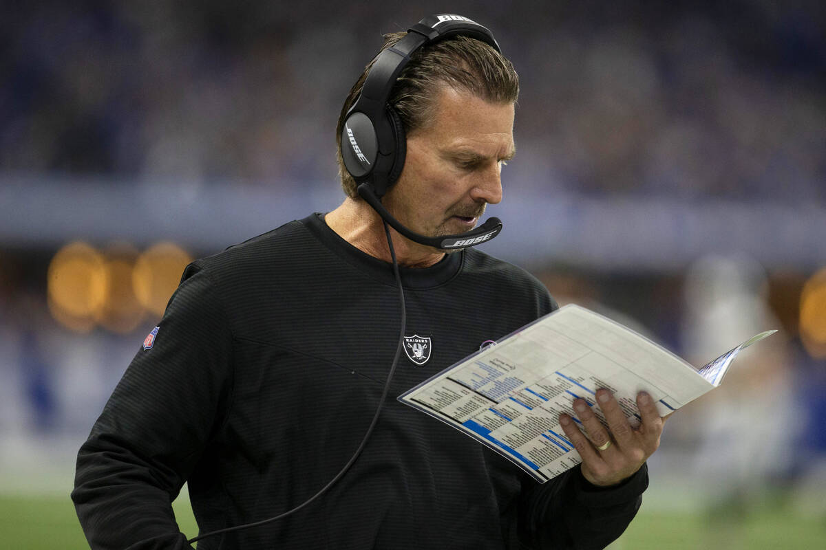 Raiders offensive coordinator Greg Olson looks at his plays during the