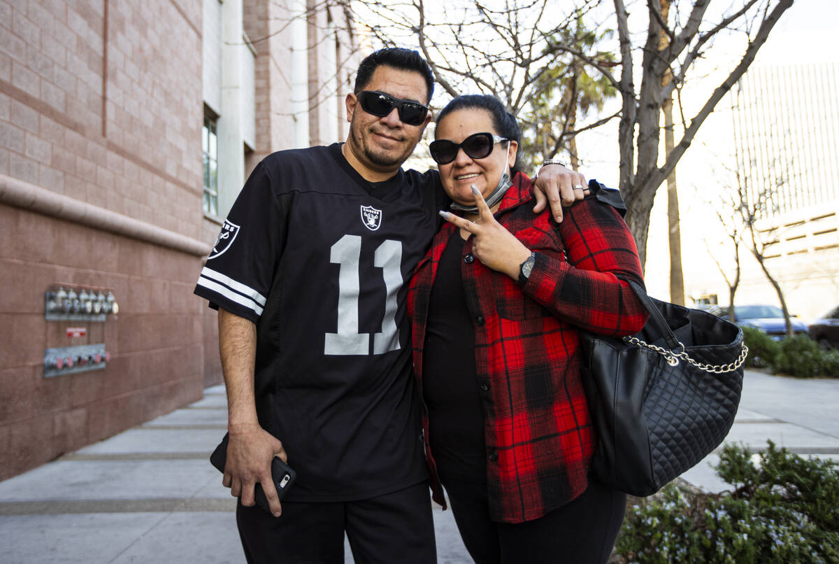 Carlos and Melissa de Leon, of Los Angeles, pose for a portrait while waiting in line at the Cl ...