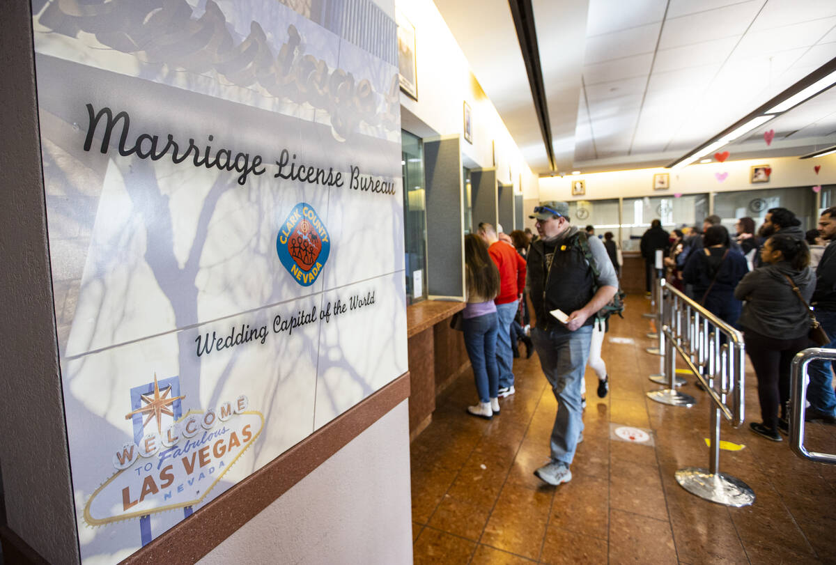 People wait in line at the Clark County Marriage License Bureau on Monday, Feb. 21, 2022, in La ...