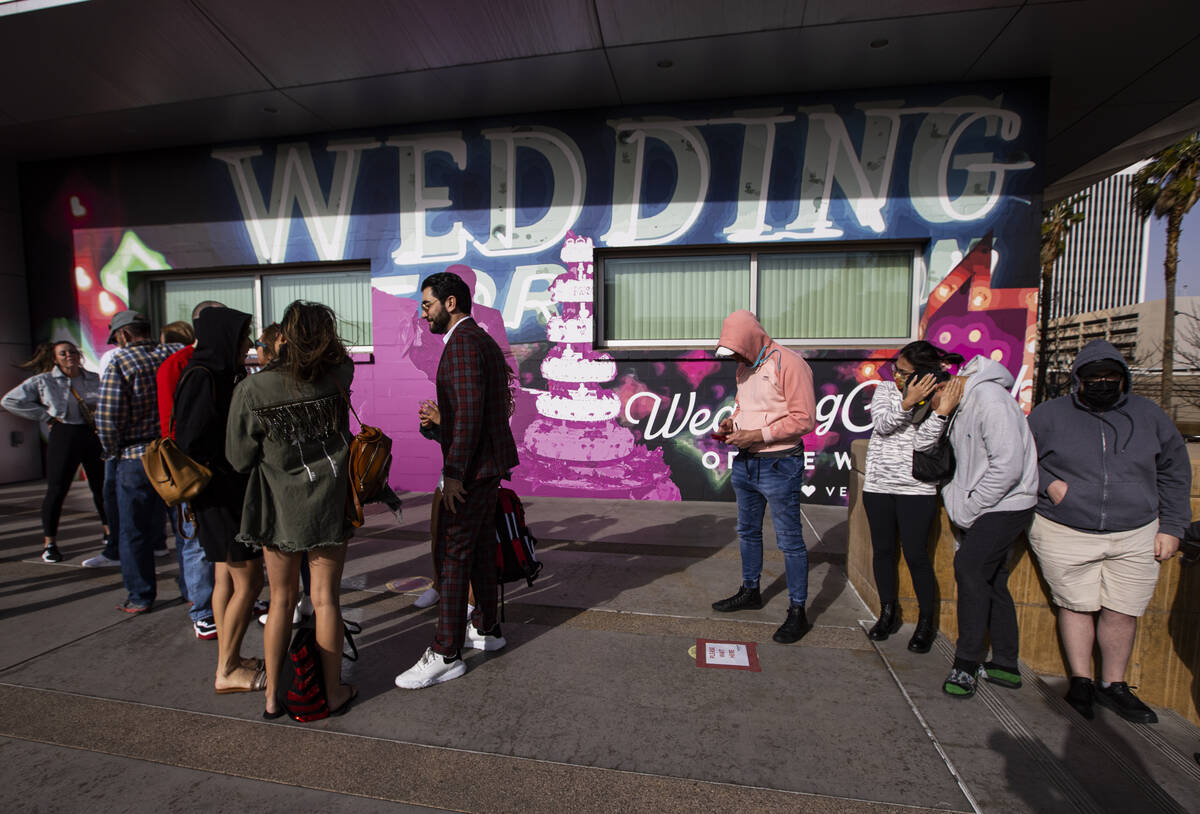 People wait in line at the Clark County Marriage License Bureau on Monday, Feb. 21, 2022, in La ...