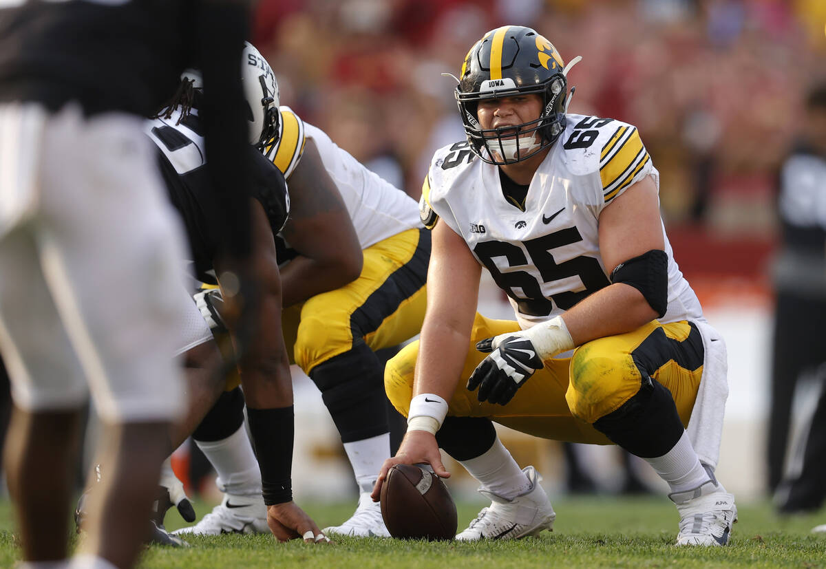 Iowa offensive lineman Tyler Linderbaum (65) gets set for a play during the second half of an N ...