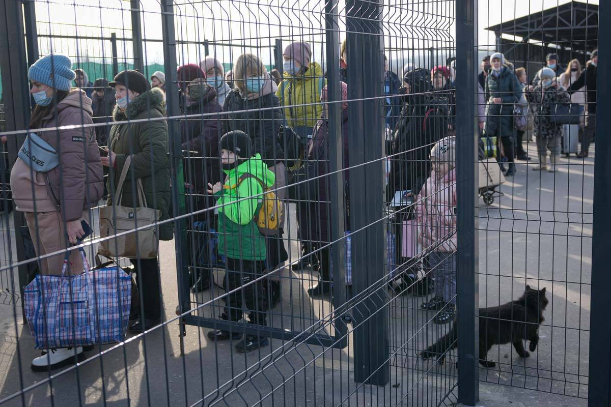 People wait to cross from pro-Russian separatists' controlled territory to Ukrainian government ...