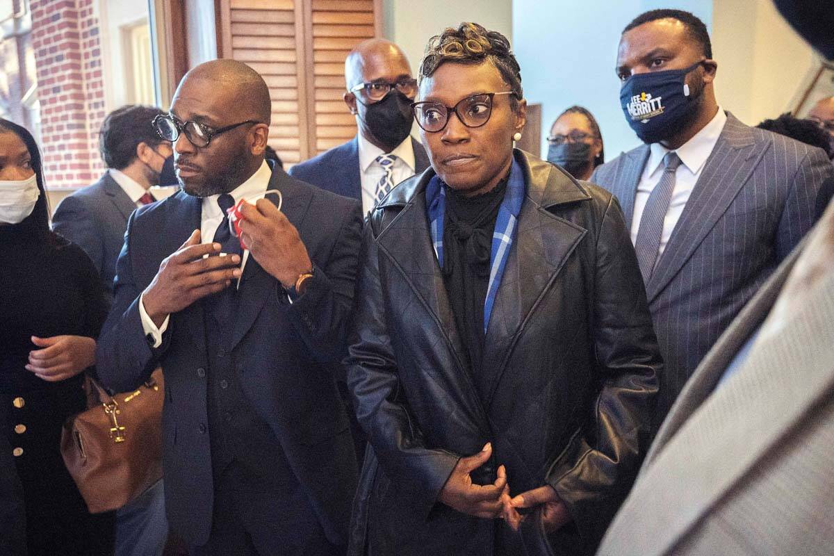 Ahmaud Arbery's mother Wanda Cooper-Jones, center, is surrounded by supporters after Superior C ...