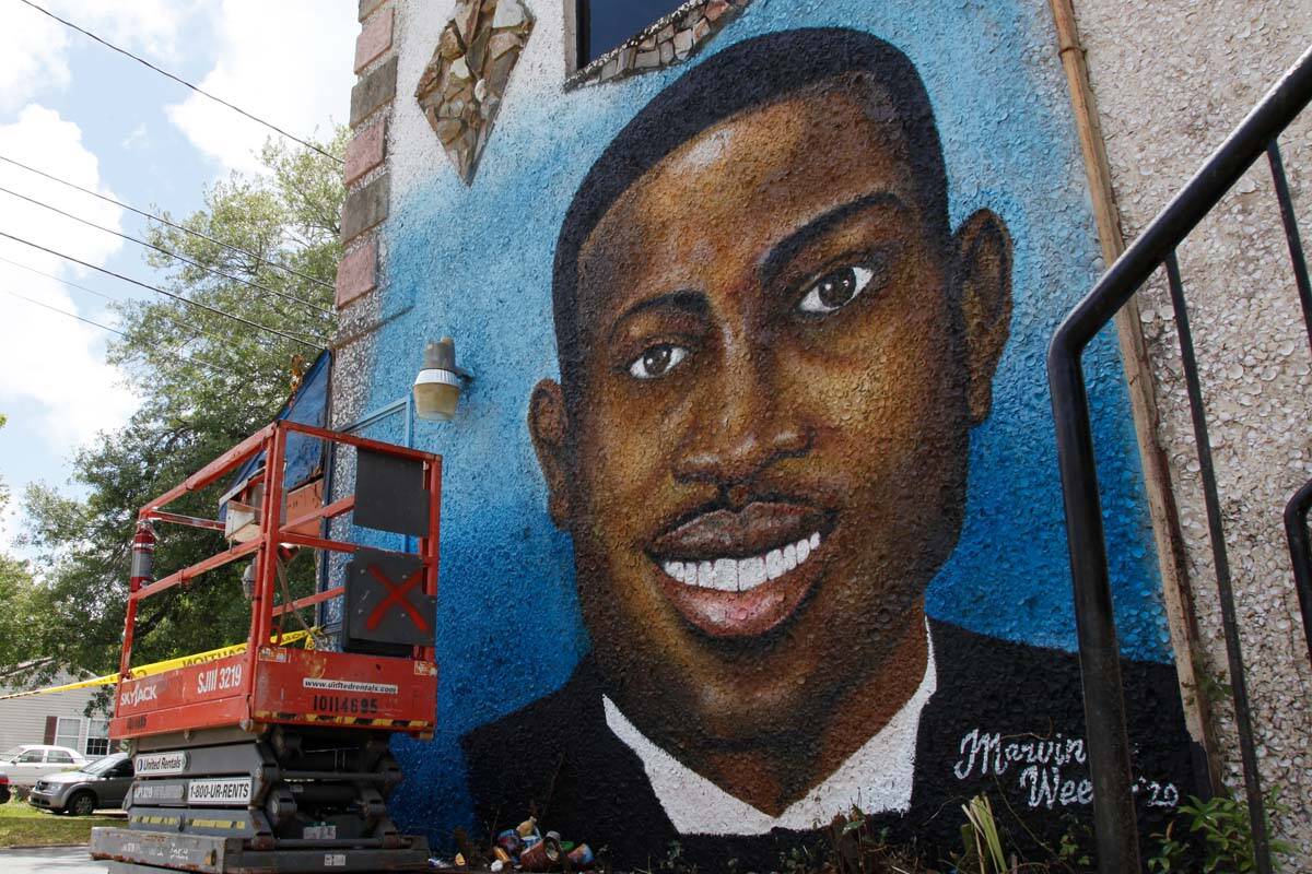 This May 17, 2020, file photo, shows a mural depicting Ahmaud Arbery in Brunswick, Ga. Travis ...