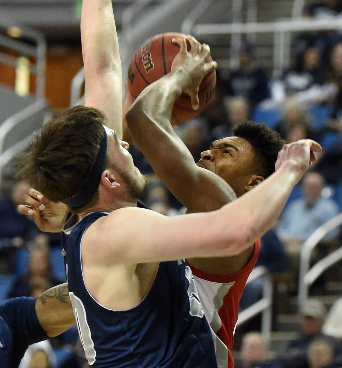 UNLV's Bryce Hamilton shoots against Nevada's Will Baker during Tuesday game at Lawlor Events ...