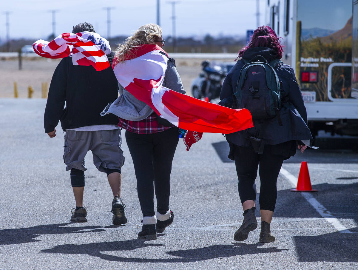 Attendees endure cold and high winds as they arrive early for The People’s Convoy stagin ...